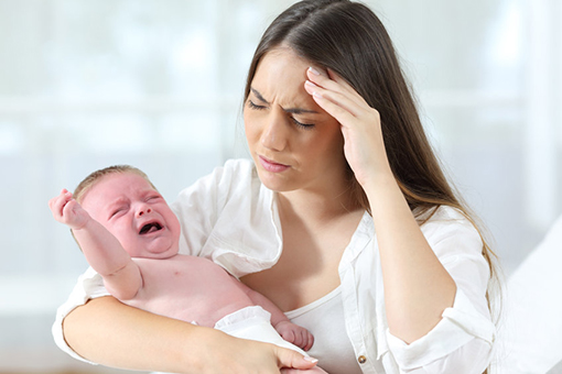 Spring Hill Mother Holding Crying Baby While Thinking Where to Find Child Support Lawyer