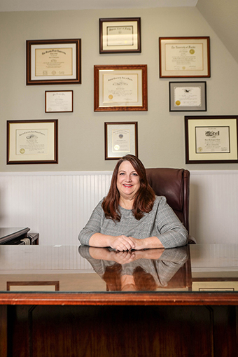Family Law Attorney Posing with Certifications in Her Office in Spring Hill FL