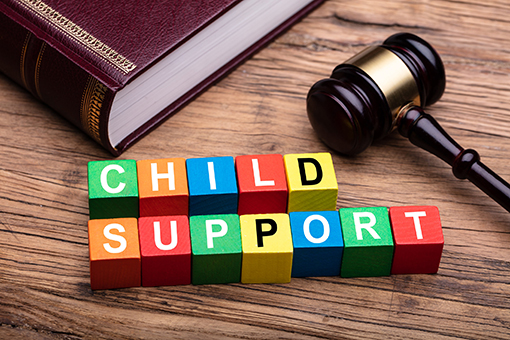 Child Support Blocks, Bible, and Mallet in a Family Law Attorney Office