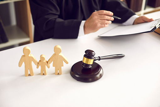 Wooden Figurines and Gavel On Top of Spring Hill Stepparent Adoption Lawyer